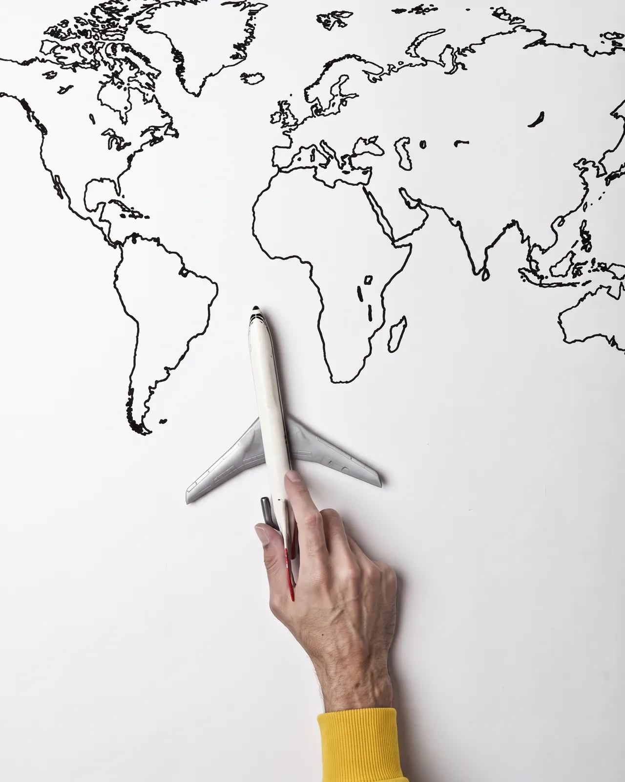 An airplane on top of a sketched world map