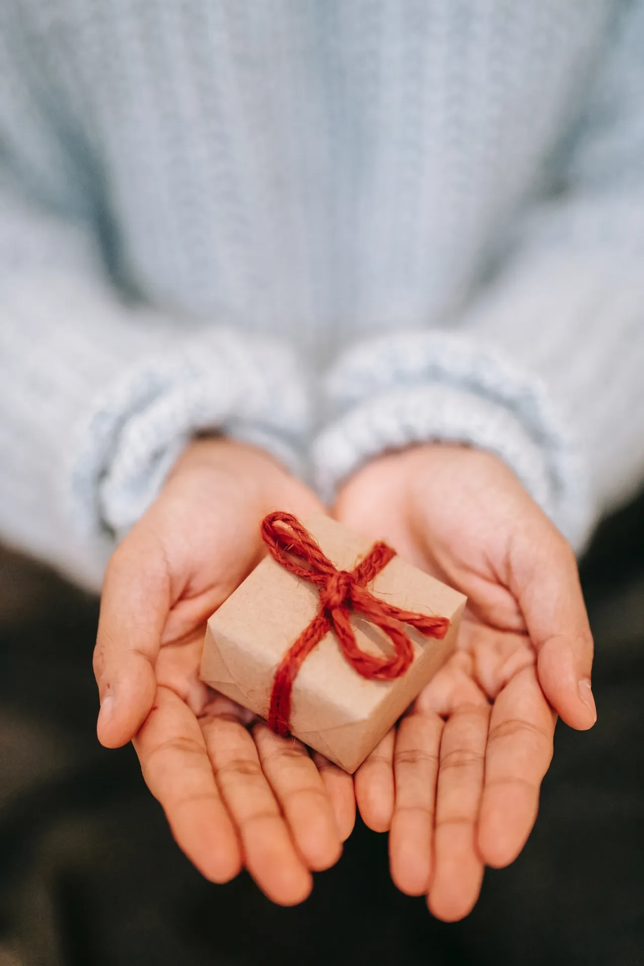 A woman handing out a small gift
